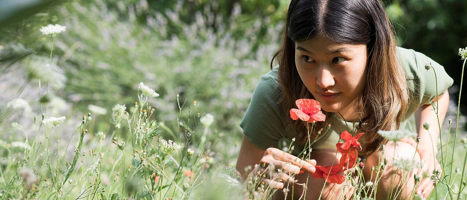 woman smelling flower