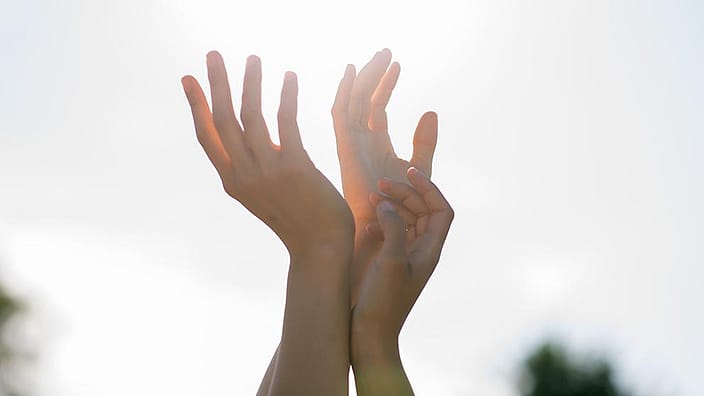 hands reaching out for sun