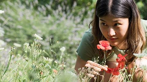 woman smelling flower